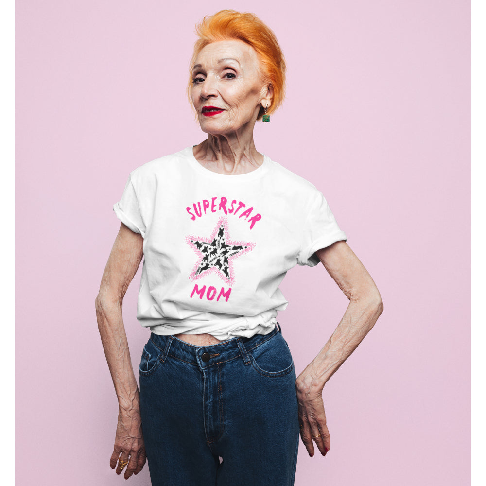 Senior woman in a white 'Superstar Mom' T-shirt featuring a pink slogan and a star-shaped design filled with black French Bulldog silhouettes.