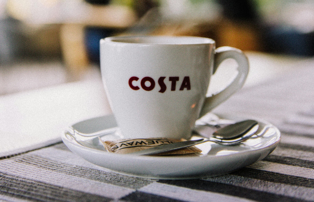 Costa Coffee cup on a café table