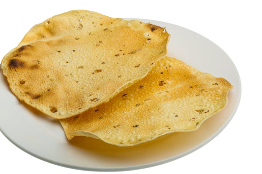 Plain poppadoms served on a white plate