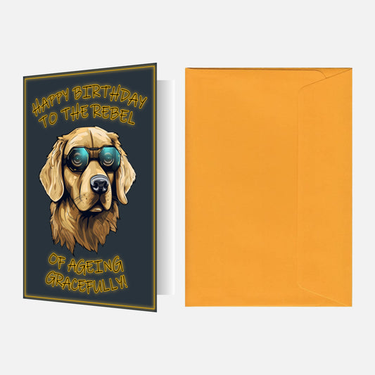 Birthday card featuring a Golden Retriever wearing sunglasses with 'Happy Birthday to the Rebel of Ageing Gracefully' text, paired with an egg yellow  envelope.