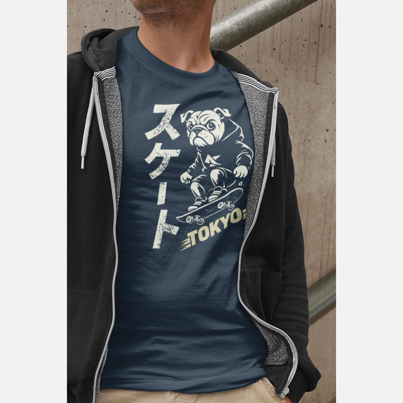 Men in an unisex navy T-shirt featuring a British Bulldog skateboarder in a streetwear illustration, with vertical Japanese “Skate” text and a muted yellow Tokyo graphic.