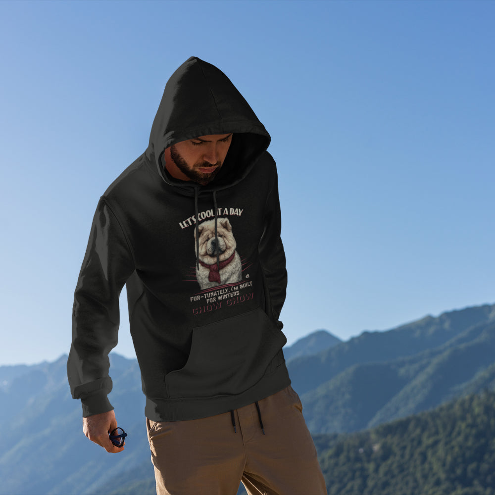 A man in the mountains, wearing a black "Let's Cool It a Day" Chow Chow hoodie, featuring a Chow Chow illustration and winter-themed text.