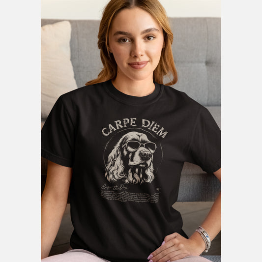 Woman in a black organic cotton T-shirt featuring a cool Cocker Spaniel in sunglasses with the slogan “Carpe Diem” and a playful definition underneath.