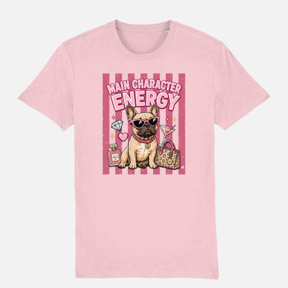A light pink t-shirt featuring a cartoon graphic of a French Bulldog wearing sunglasses, next to a leopard print handbag and diamonds, with the text 'MAIN CHARACTER ENERGY' on a pink striped background.