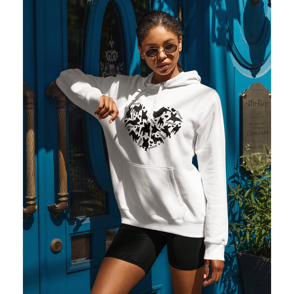 A woman in a white hoodie featuring a heart-shaped design filled with black French Bulldog silhouettes and the word 'Frenchie' repeated throughout.