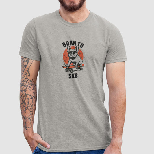 Man in a heather grey organic cotton T-shirt featuring a French Bulldog wearing sunglasses on a red skateboard with “Born to Sk8” text in bold streetwear style