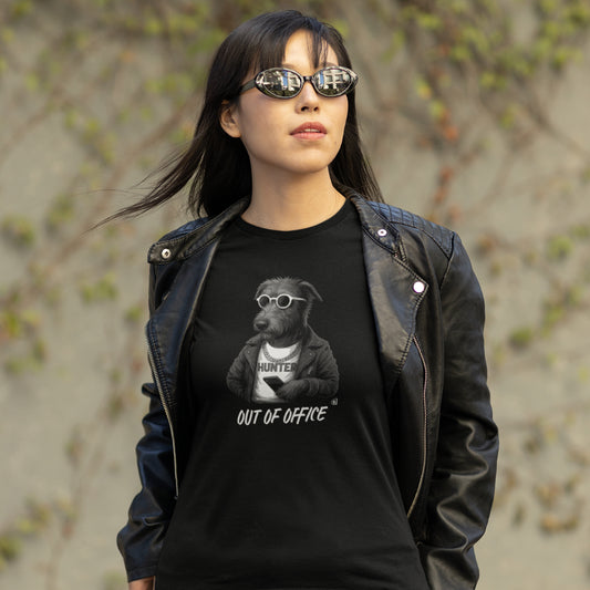 Woman in a black Irish Wolfhound 'Out of Office' T-shirt with leather jacket, sunglasses, and phone on organic cotton tee.