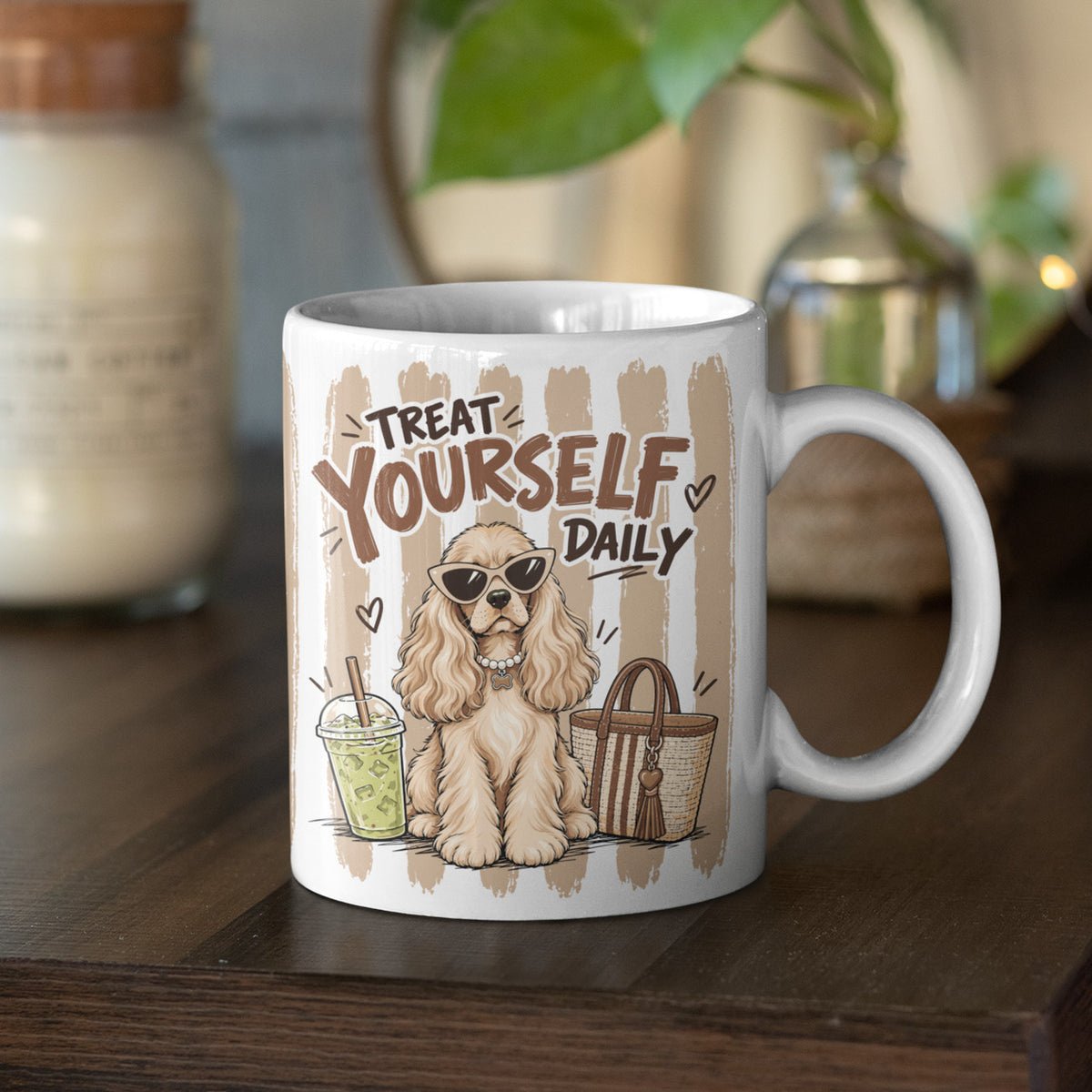 Treat Yourself Daily Cocker Spaniel mug on a wooden table, with a sunglasses-wearing dog and latte-coloured stripes