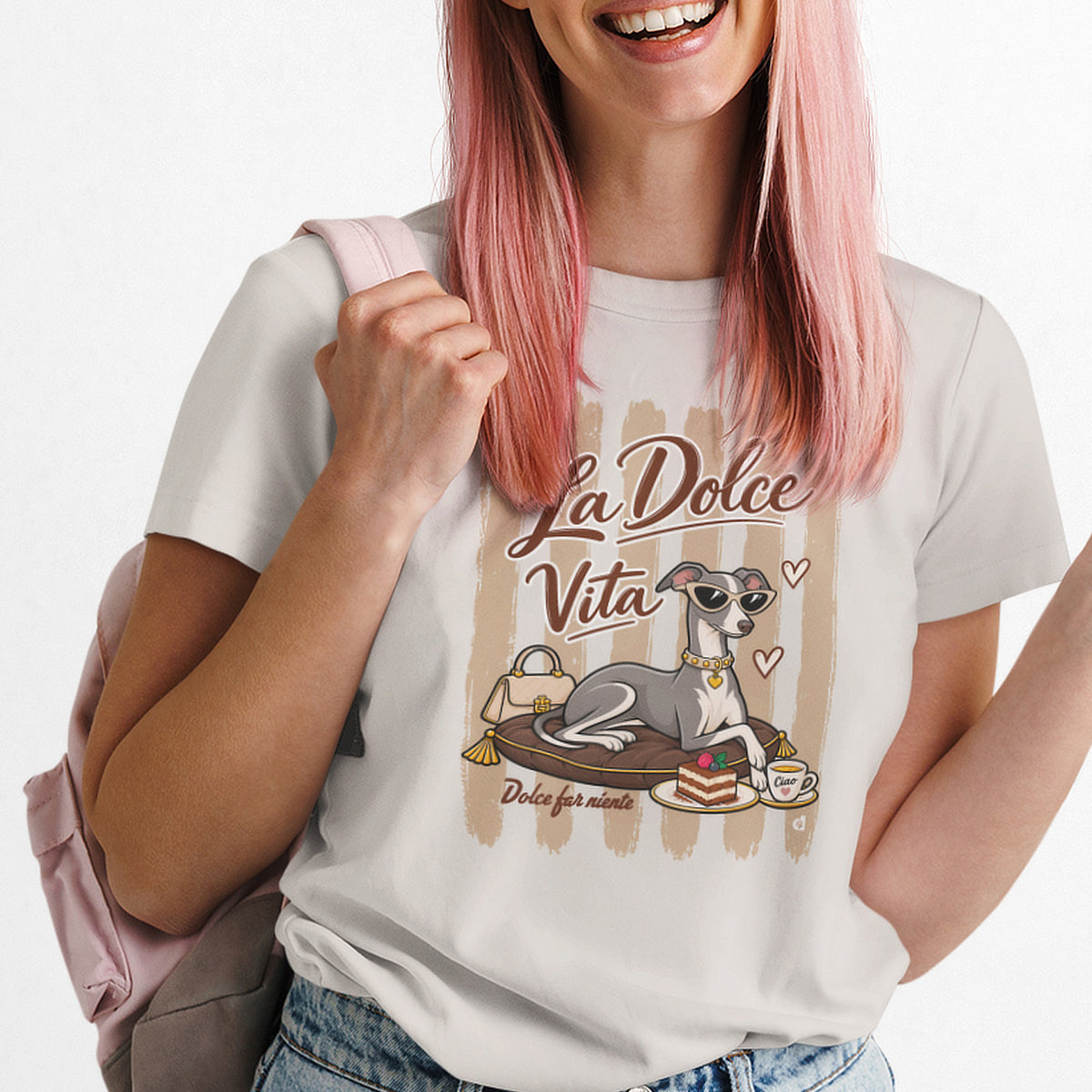 A woman is wearing a Vintage White T-shirt featuring a graphic print of an Italian greyhound dog wearing sunglasses, sitting on a cushion with a cup of coffee, under the text 'La Dolce Vita'. 