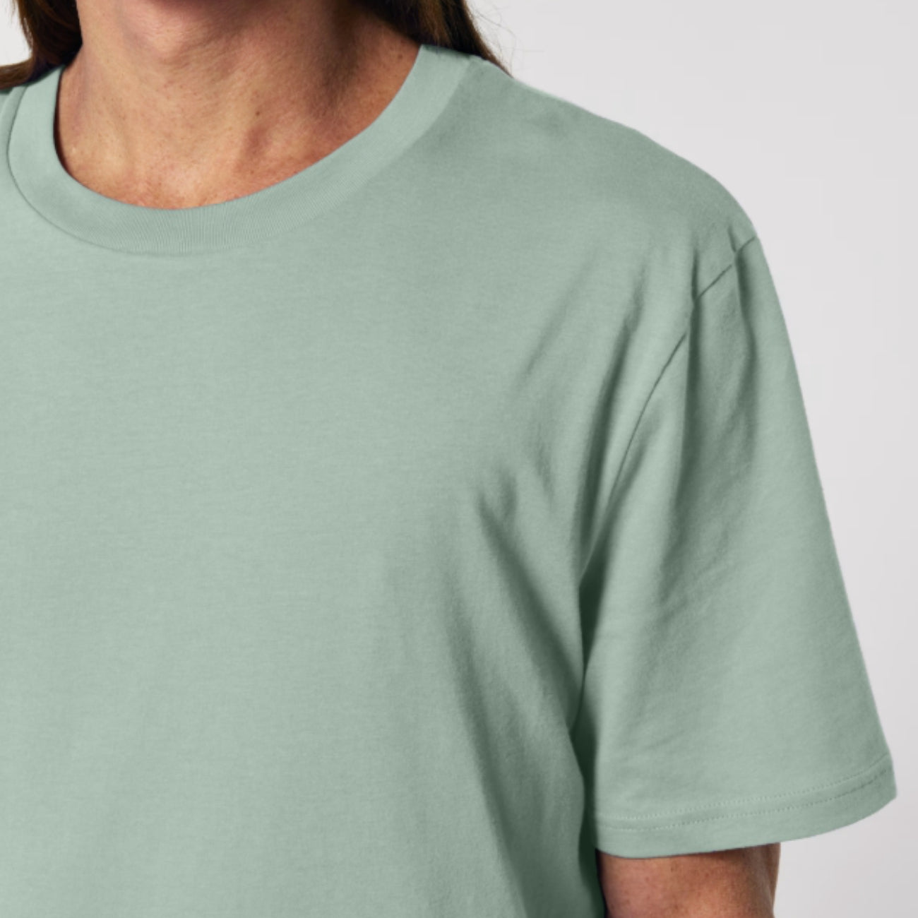 Aloe coloured t-shirt worn by a person on a white background