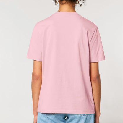A person shown from the back wearing a cotton pink short-sleeve crewneck t-shirt and light blue jeans, against a plain light grey studio background.