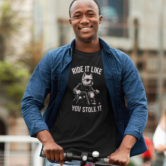 Men in a black T-shirt featuring a West Highland Terrier riding a motorcycle, wearing sunglasses and a leather jacket, with the slogan “Ride It Like You Stole It” displayed in arched text above and below the illustration.